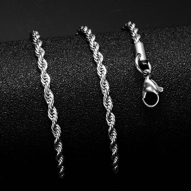 Gold Cuban Link Chain displayed on a black surface showcasing its fine craftsmanship and clasp detail.